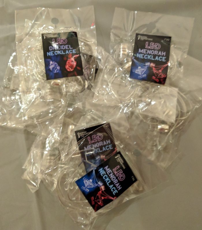 LED Dreidel necklace in packaging
